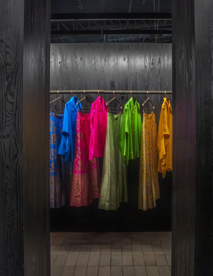 The timber clothing racks house multihued ensembles designed by Payal Khandwala; Photograph courtesy Studio Organon