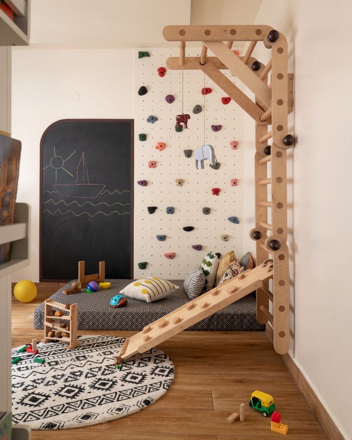 A plush ‘Obeetee’ rug and a playful ladder toy set from 'Bloon Toys' fill the kids' bedroom with whimsical charm; Photography by Nayan Soni