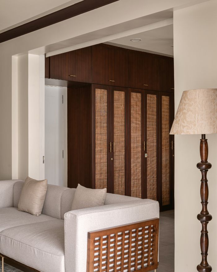 A view of the guest bedroom from the living room with the sliding door open. A ‘Fabindia’ lamp stands in elegance bearing a finely crafted traditional form; Photography by Nayan Soni