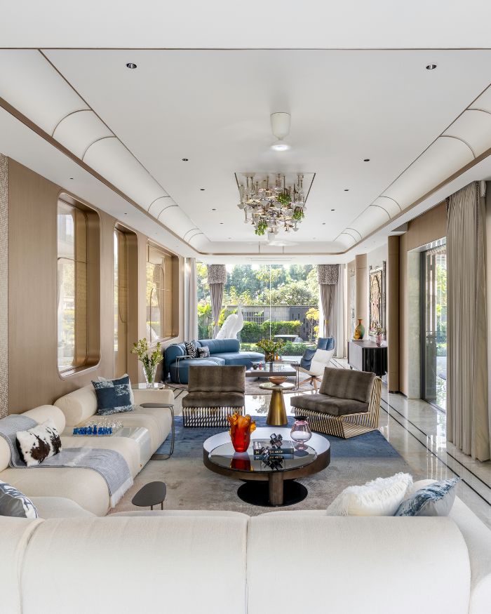 Statement furniture from Versace, Rugiano, Cattelan Italia, Natuzzi, B&B Italia and Arketipo by Vita Moderna anchor the space. Lighting by Glass Forest and Hybec, rich Acespace veneer, Hands Carpet rugs, Genuine Marble finishes, and an Anemos fan complete this luxe ensemble; Photography by Phx India