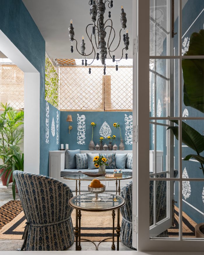 The outdoor lounge area features hand painted murals in tones of deep
blues to bring out an Indian sensibility in the space; Photography by Tarang Goyal