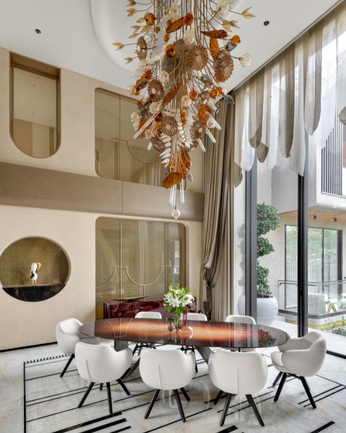 Vita Moderna furniture and a striking Roche Bobois bar unit set the tone. Bombay Paints’ textured walls and ceiling meet double-height P3 glass, with glow from Glass Forest and Hybec lights. Finished with Genuine Marble, Acespace veneer, and elegant drapes by Sangeeta Seth; Photography by Phx India