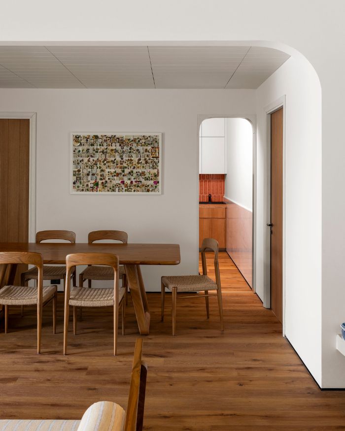 A discerning confluence of clean design, wooden furniture, and pristine white walls blanket this space; Photography by Lokesh Dang