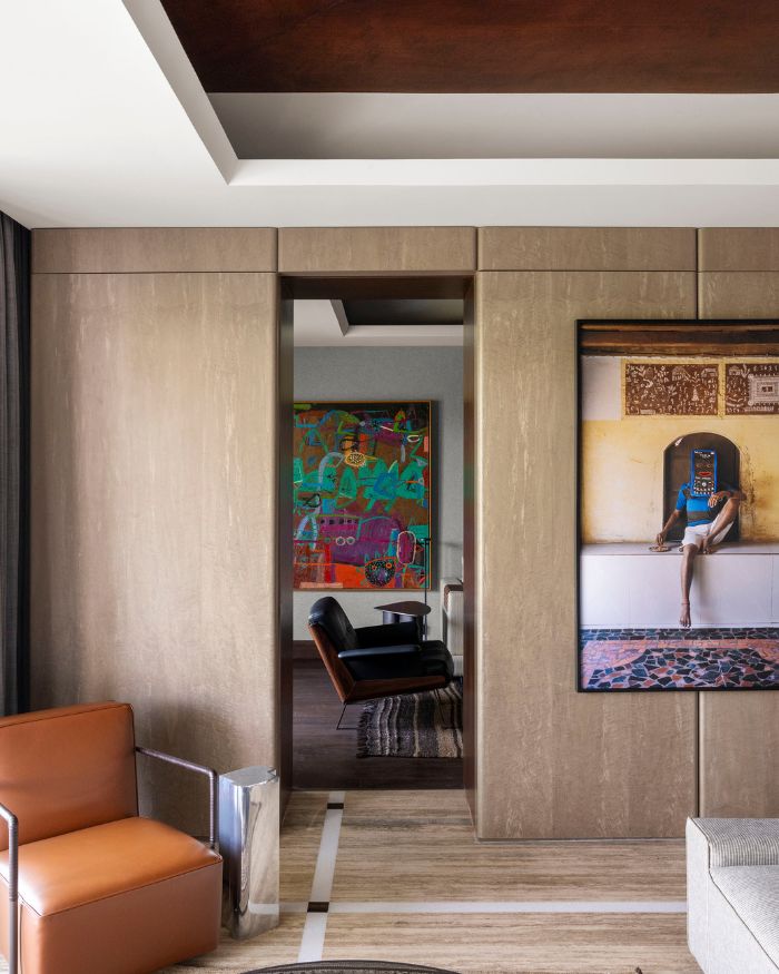 The artworks are by Gauri Gill and Nidhi Aggarwal, and the black wall sculpture by Martand Khosla, while the chair is from Flexform, coffee table and armchair from Minotti and rug from Jaipur Rugs; Photography by Lokesh Dang