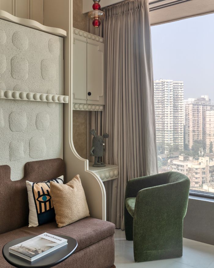 A thoughtfully integrated study nook by the window offers an inspiring workspace with panoramic city views, making the room both functional and imaginative. The lights are by VLights, artefacts by Golden Triangle and carpets and rugs from Loop by LJ;  Photography by Pulkit Sehgal