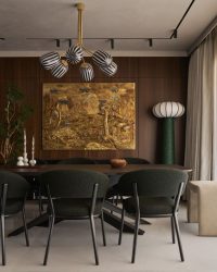 A sleek pendant light occupies the limelight of the dining area, a dramatic entity perfectly paired with minimalist modern dining chairs and a simple table; Photography by Yadnyesh Joshi