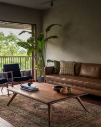 The living room has a sofa from West Elm, armchairs and a centre table from Tianu, and cushions from Altrove and Craft & Kar; Photograph Courtesy Wabi-Sabi Studio by Janvi Thakkar