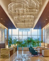 The lobby has cascading chandeliers and intricate wall art that pays homage to the region’s craft legacies; Photography by Paul Raftery
