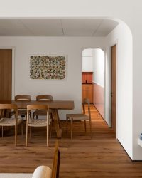 A discerning confluence of clean design, wooden furniture, and pristine white walls blanket this space; Photography by Lokesh Dang