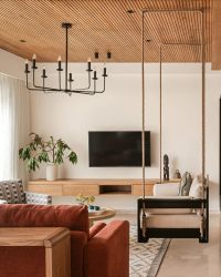 The living room has custom-made furniture, a chandelier from Black Steel and rug from Jaipur Rugs; Photography by Nayan Soni