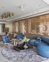 Natuzzi by Vita Moderna furniture takes center stage, paired with custom pieces by Furniture_React. Warmth flows through Acespace veneer, Hands Carpet rugs, and Genuine Marble accents, while Glass Forest decorative lights, Hybec lighting, and an Anemos fan elevate the ambiance; Photography by Phx India