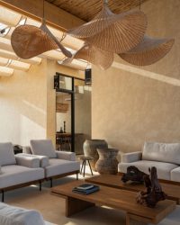 The micro-cement flooring by Concrete Works establishes an earthy feeling, while the bamboo-clad ceiling, installed by artisans from Bamboo India filters light in rhythmic patterns; Photograph by Shamanth Patil