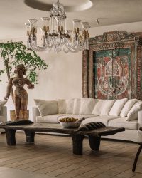 An antique chandelier from Taherallys crowns the oversized Naga coffee table with a marble fruit artwork titled Banana in a Basket by Mayadhar Sahu (sourced by Hunt Interiors from Chemould CoLab); Photography by Ishita Sitwala